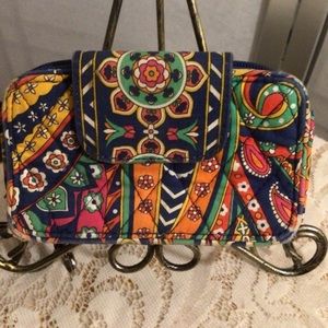 Vera Bradley colorful small wallet and cell phone.